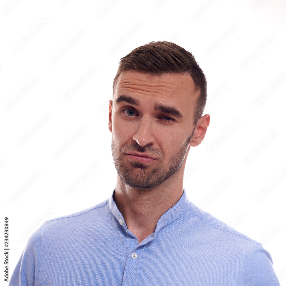 Casually handsome. Confident young handsome man in jeans shirt keeping arms crossed and smiling while standing against white background