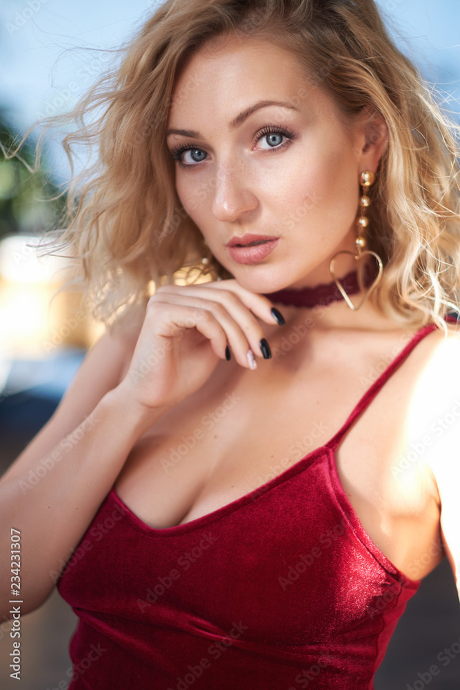 Closeup portrait of a beautiful blond young woman looking at the camera Closeup portrait of a beautiful blond young woman looking at the camera