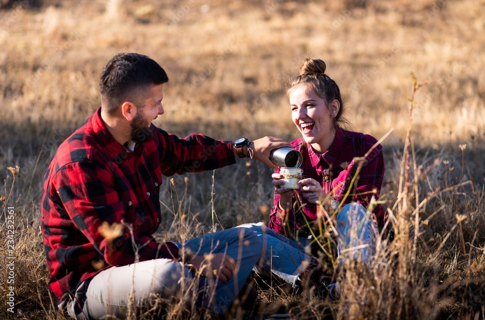 Couple sharing a cup of coffee outdoors Couple sharing a cup of coffee outdoors