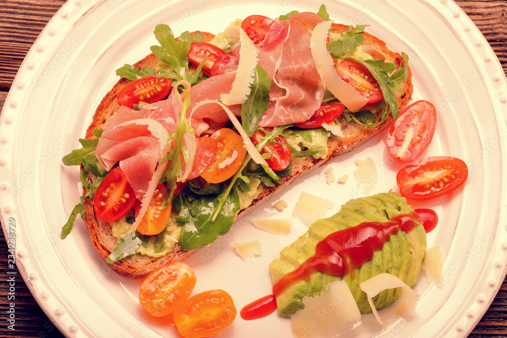 Avocado sandwich on fresh bread with arugula