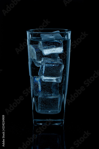 Silhouette of a glass with water on a black background