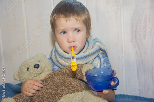 The baby is ill. The child takes the pill. The child measures the temperature.
