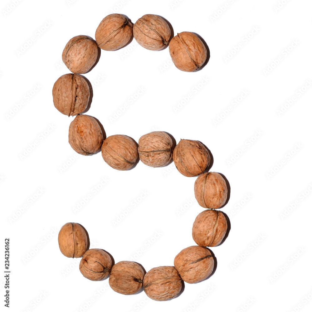 Letter S made with nuts to form a letter of the alphabet. Fruit letters on a white background. Letter S made with nuts to form a letter of the alphabet. Fruit letters on a white background.
