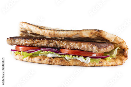 Greek pita with meat, salad, tomato and sauce isolated on white
