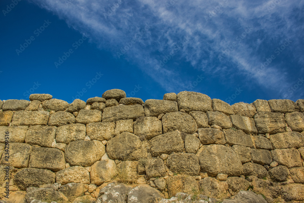 old antique stone wall texture board with empty blue sky background, copy space old antique stone wall texture board with empty blue sky background, copy space