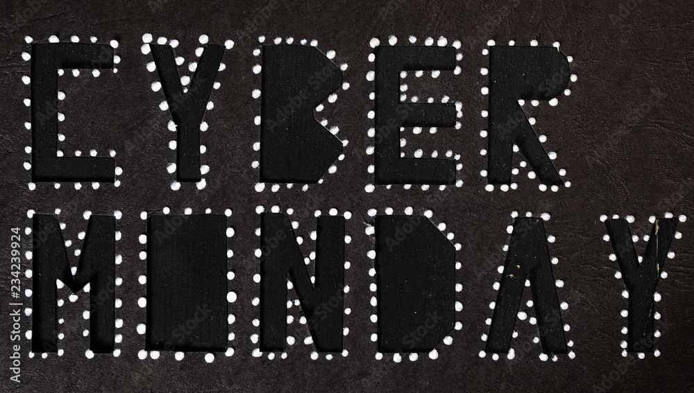 Words CYBER MONDAY on black carton paper