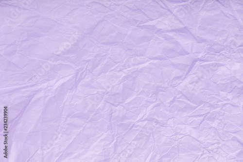Texture of crumpled violet wrapping paper, closeup. Lilac old background.