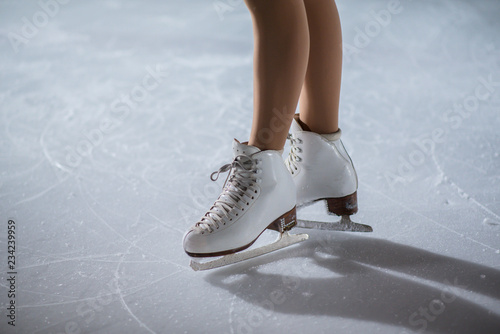 A cute young ice skater is waiting for her show on ice to start.