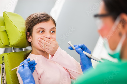 Little girl is afraid of dentist.
