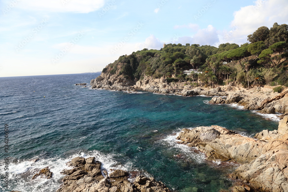Waves beat on the rocky shore, Mediterranean Sea, Seaside villas in catalonia in costa bravo Waves beat on the rocky shore, Mediterranean Sea, Seaside villas in catalonia in costa bravo