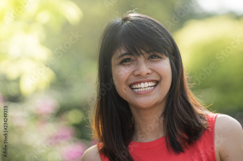 young cheerish asian woman excecise in a park at morning