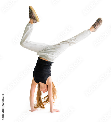 Canvas-taulu Attractive flexible teenage girl doing handstand on light background