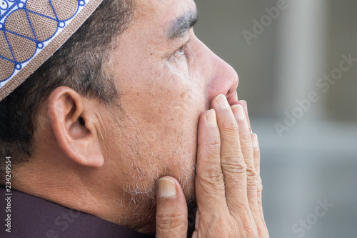 Middle age muslim man praying at mosque. photo