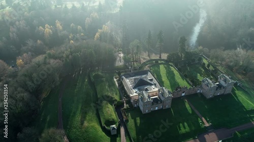 Aerial footage over Chatelherault hunting lodge on an early hazy winters day with a low sun throwing long shadows. photo