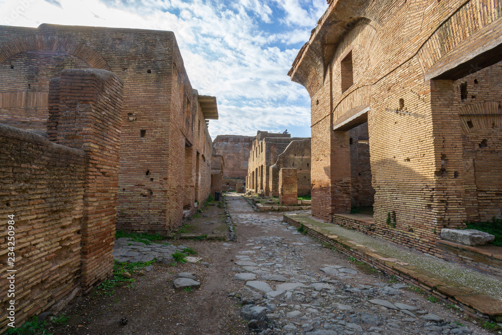 Ostia antica in Rome, Italy. Archaeological Roman empire street view with original ancient Roman buildings