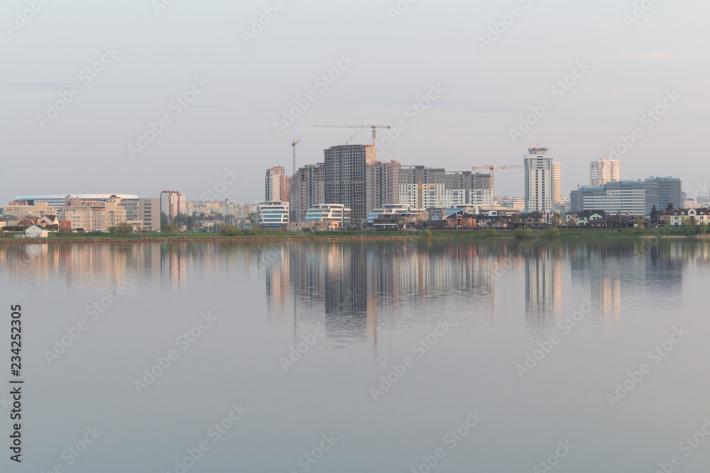 Naklejka premium The reflection of the city in the lake