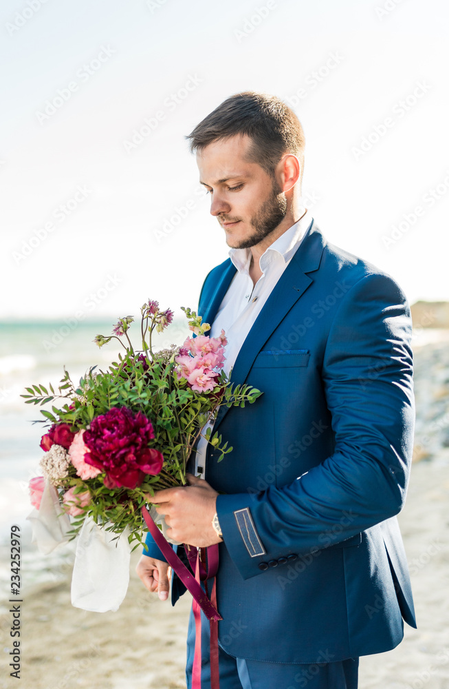 Groom getting ready in the morning for wedding ceremony on the beach Groom getting ready in the morning for wedding ceremony on the beach