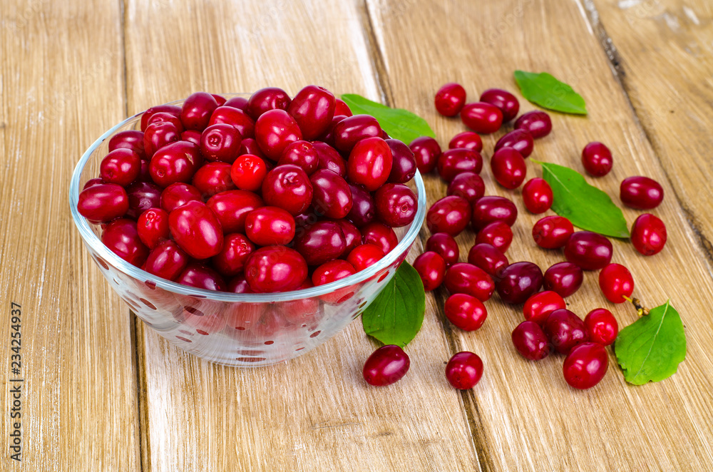 Autumn ripe cornel berries on wooden table Autumn ripe cornel berries on wooden table