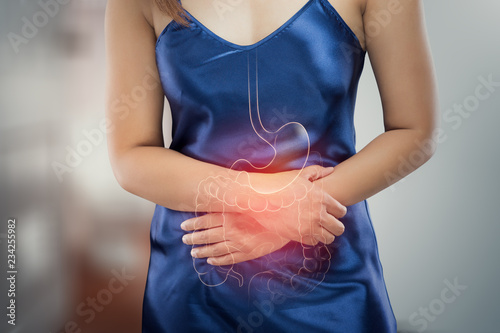 Asian woman in satin nightdress wake up for go to restroom, The photo of internal organs is on the women's body against toilet background, Healthcare and lifestyle concept. photo