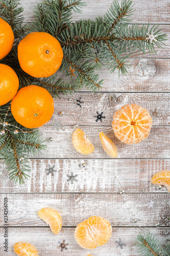 Peeled tangerines on wooden background