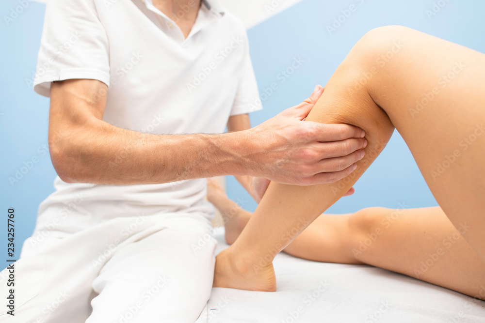 Delicate calf massage in a professional physiotherapist's studio Delicate calf massage in a professional physiotherapist's studio