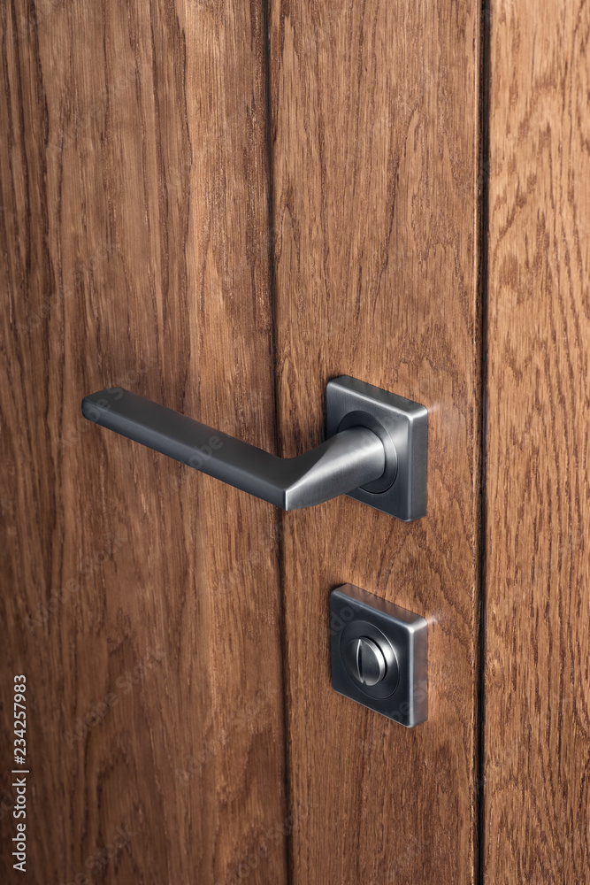 Obraz premium Close - up of modern steel door handle and bathroom lock