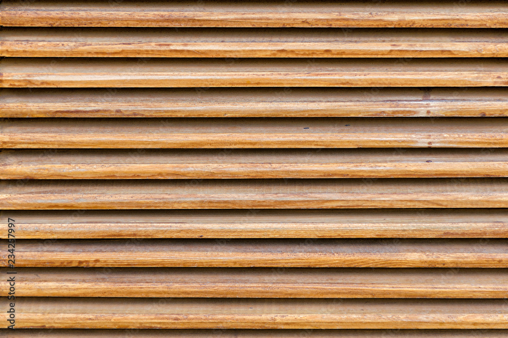 Parallel wooden slats texture. Wooden blinds, as an element of decor. Interior ventilation. Wood background, close up. Parallel wooden slats texture. Wooden blinds, as an element of decor. Interior ventilation. Wood background, close up.