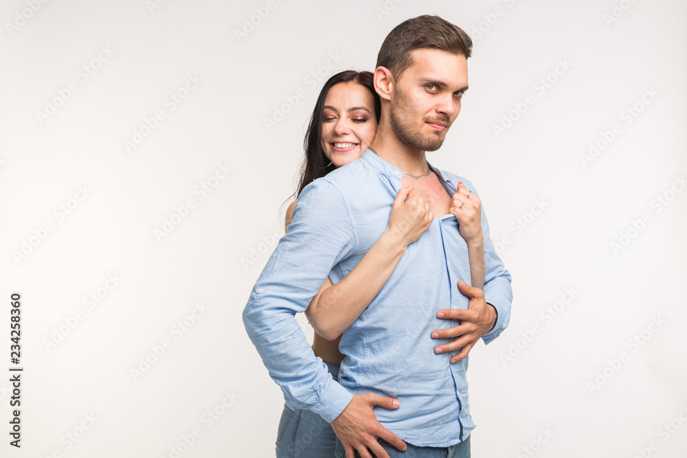 Naklejka premium Relationship and love concept - Portrait of funny couple on white background with copy space