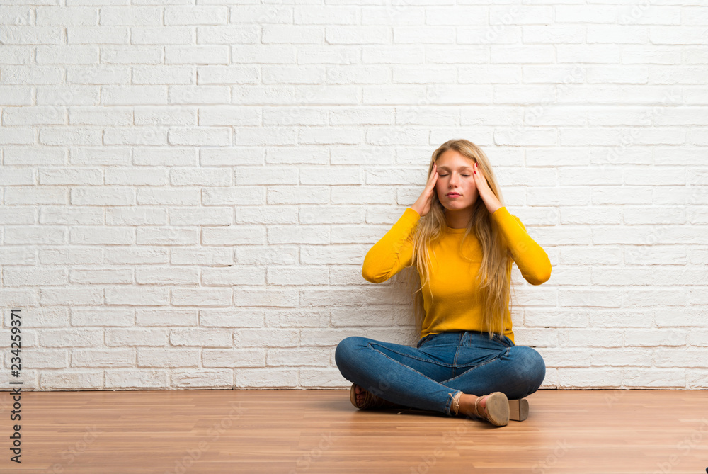 Young girl sitting on the floor unhappy with something. Negative facial expression Young girl sitting on the floor unhappy with something. Negative facial expression