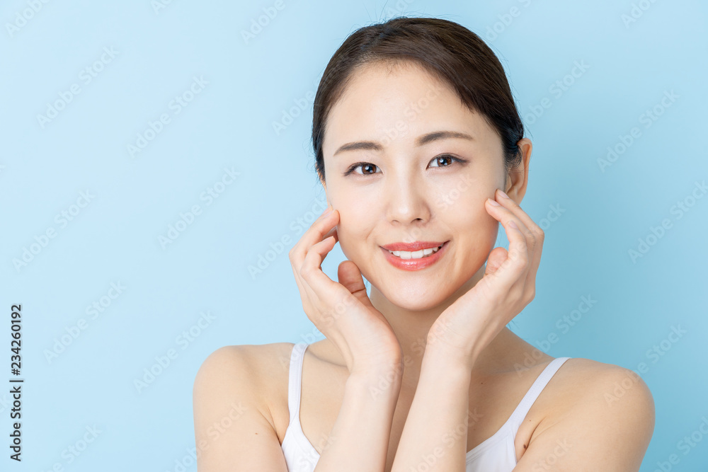 attractive asian woman beauty image on blue background attractive asian woman beauty image on blue background