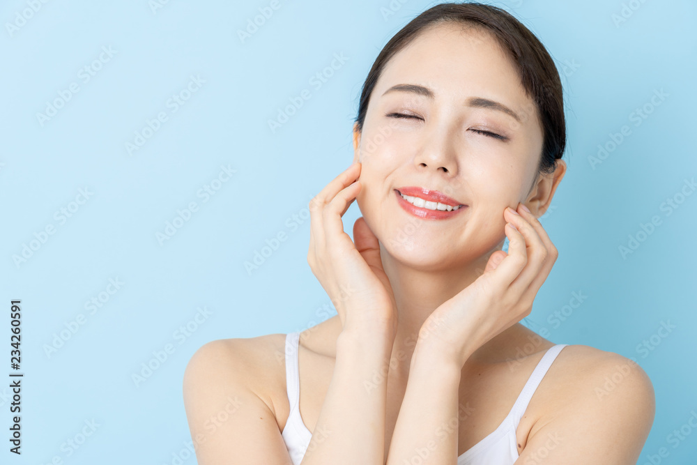 attractive asian woman beauty image on blue background attractive asian woman beauty image on blue background