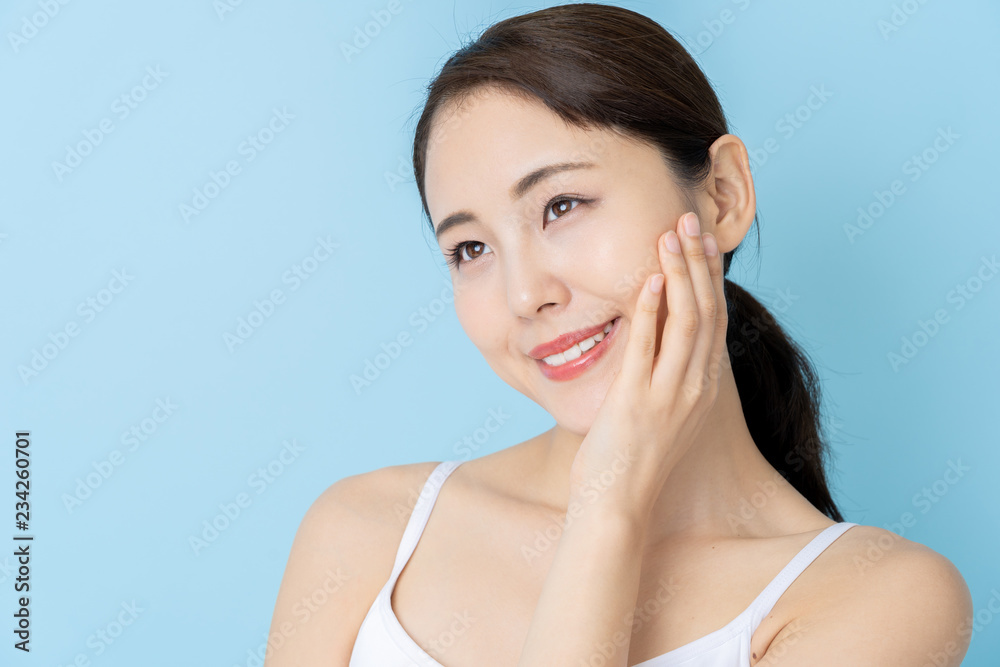 attractive asian woman beauty image on blue background attractive asian woman beauty image on blue background