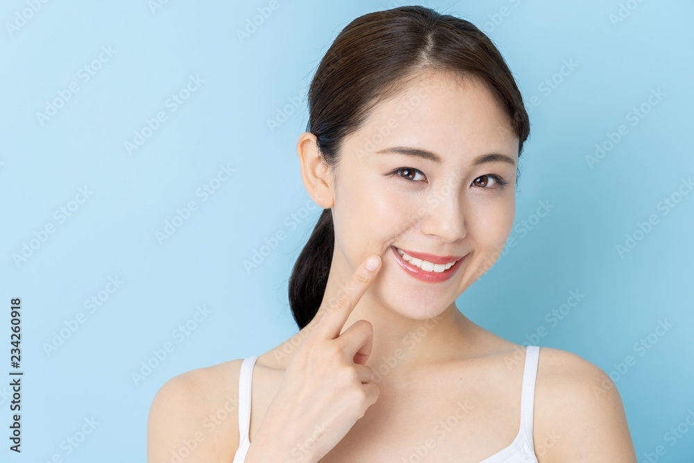 attractive asian woman beauty image on blue background attractive asian woman beauty image on blue background