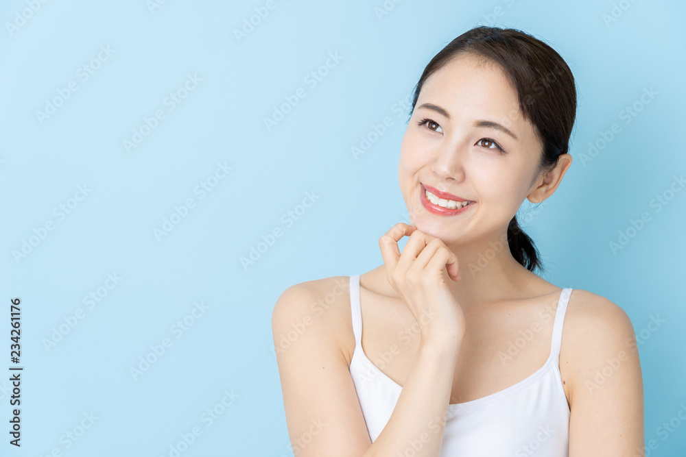 attractive asian woman beauty image on blue background attractive asian woman beauty image on blue background