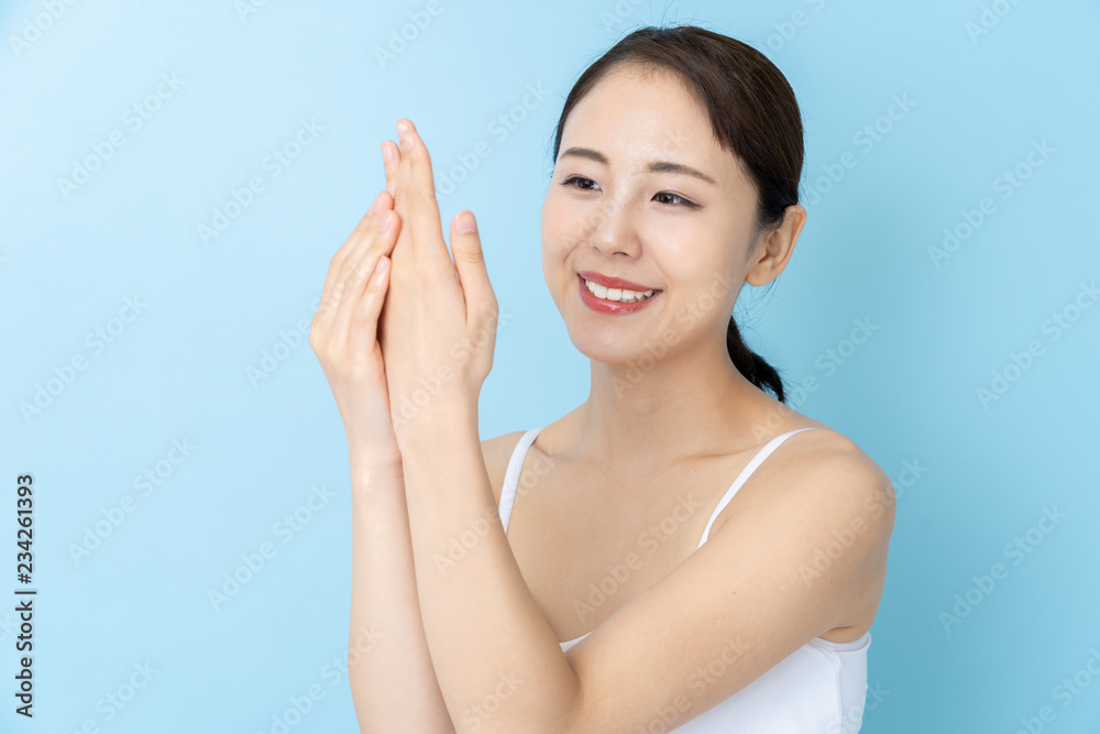 attractive asian woman beauty image on blue background attractive asian woman beauty image on blue background