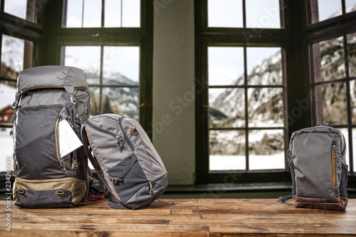 Backpack on table and retro window landscape 