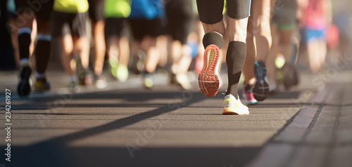 Marathon running in the light of evening, detail on legs