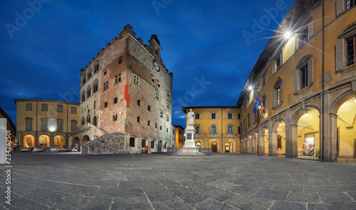 Prato, Italy. Panorama of Piazza del Comune square with historic building of medieval Town Hall at dusk photo