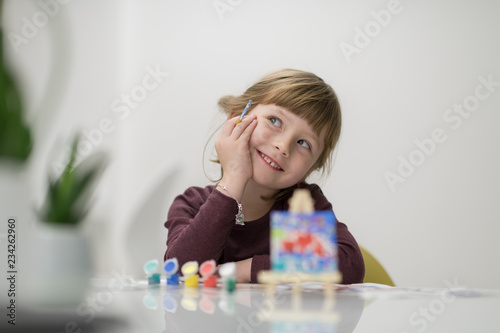 little girl painting on canvas