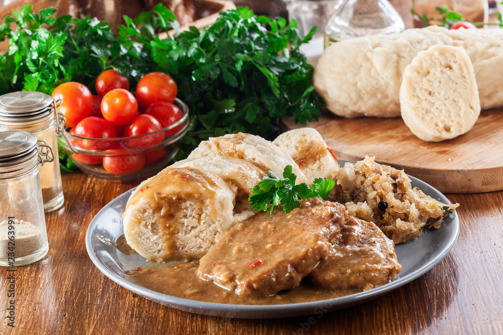 Pork loin in gravy with bread dumplings and sauerkraut Pork loin in gravy with bread dumplings and sauerkraut