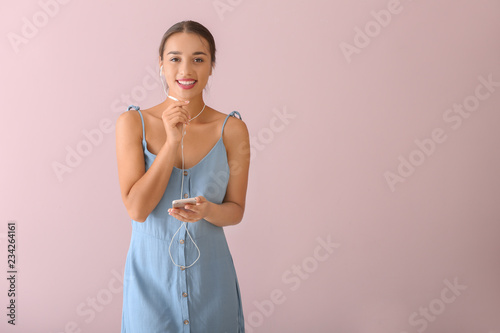 Beautiful young woman liste...