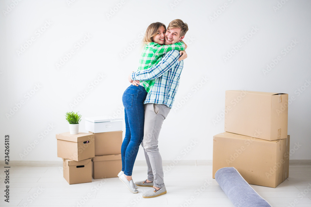 Relocation, new home and real estate concept - Young couple in their new flat Relocation, new home and real estate concept - Young couple in their new flat