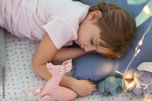 Cute little girl with toys ...