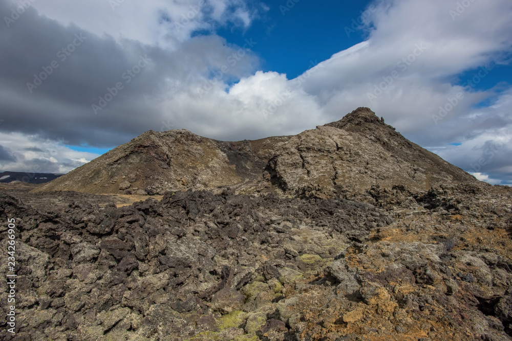 The Krafla is volcanic area in Iceland. Amazing lava field and dramatic sky with dark clouds. The Krafla is volcanic area in Iceland. Amazing lava field and dramatic sky with dark clouds.