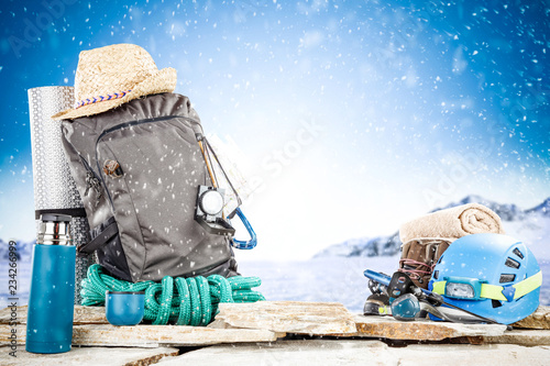 Winter photo of travel backpack and snow flakes 