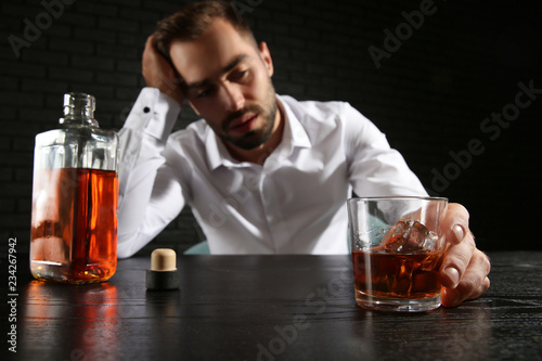 Drunk man with glass and bo...