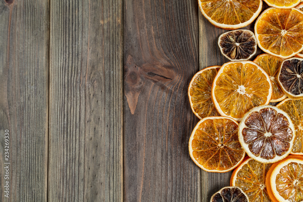 Dry slices of orange on broom wooden background, top view Dry slices of orange on broom wooden background, top view