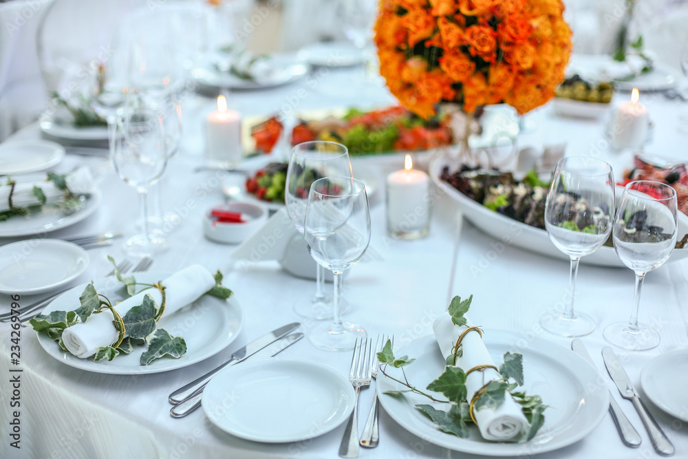 Holiday table setting decorated with flowers and candles.