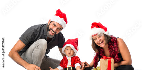 Adorable little baby with his parents at christmas parties on isolated white background