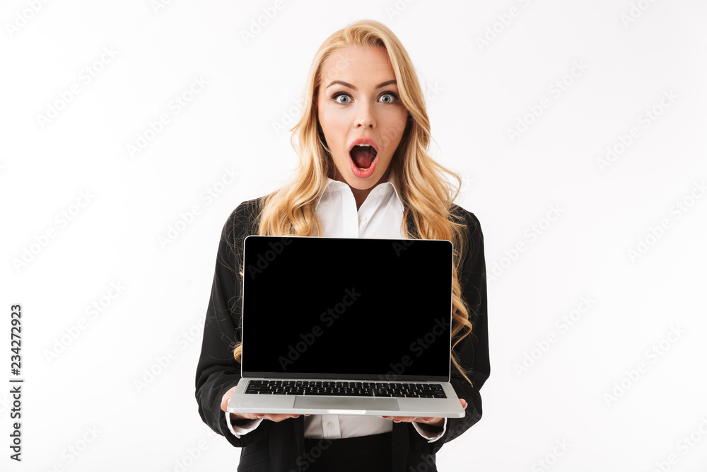 Photo of shocked businesswoman wearing office suit holding laptop with black screen, isolated over white background in studio Photo of shocked businesswoman wearing office suit holding laptop with black screen, isolated over white background in studio